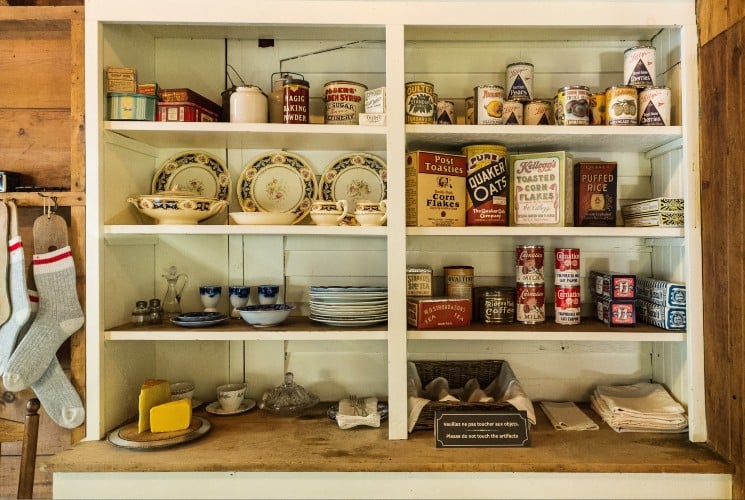 Hutch with shelves filled with various antique items in a store